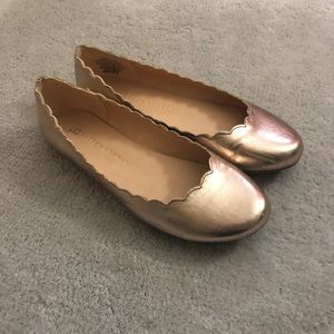 Rose gold Lauren Conrad scalloped flats.